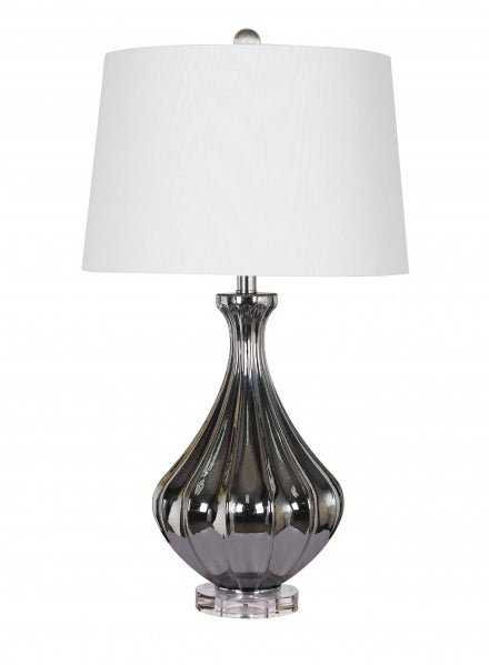 A Metalic Chrome Glass Table Lamp With A White Shade And A Crystal Base